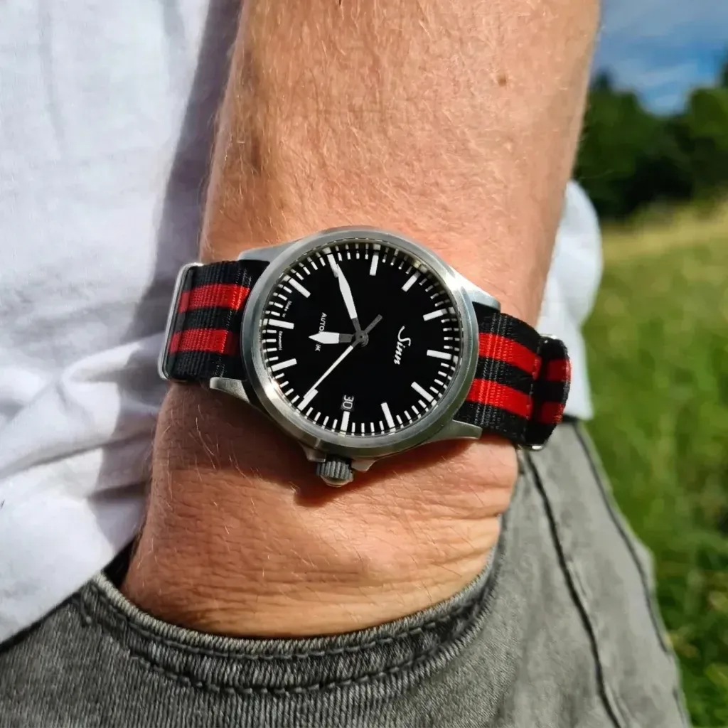 Sinn 556 on Red Bond Single Pass Seat Belt strap